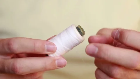 Taking white thread from a bobbin Stock Footage 73506178