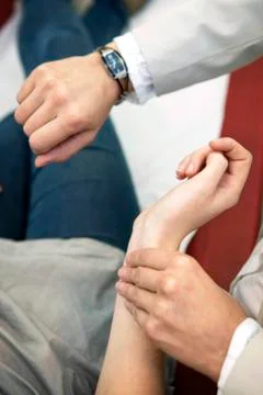 Taking a woman's pulse Stock Photos