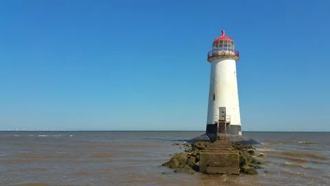 Talacre Point of Ayre lighthouse under Welsh blue sky at low tide Fotos de archivo