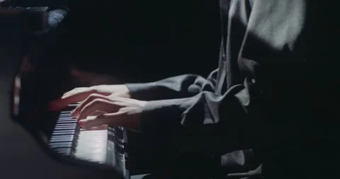 A talented and elegant pianist is performing beautifully in the dim and Stock Footage 285647462