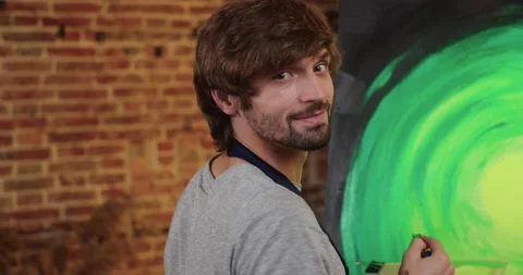 Talented Artist is turning to the Camera with charmingly Smile. Young Pinter is Stock-Footage 141582827