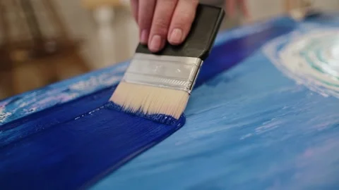 A talented artist, using a brush, creates a modern masterpiece of oil painting Stock Footage 146805492