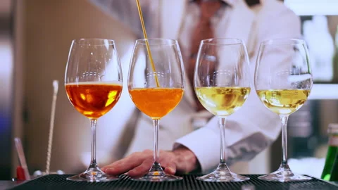Talented barkeeper pouring Aperol Spritz mixing it with refreshing Prosecco in Stock Footage 344763145