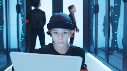 Talented boy hacker coding at laptop monitor hacking a modern database server Stock Footage 120697595