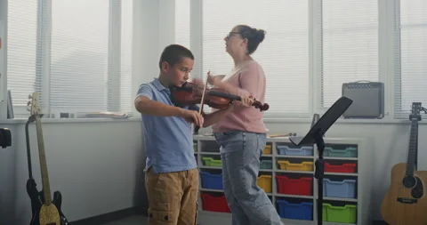 Talented Boy Playing Violin During Music Lesson. Teacher Supporting and Teaching 스톡 동영상 317548342