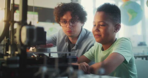 Talented Boy Sitting at the Table with Teacher, Studying Printing on Advanced 3D Stock Footage 311674797