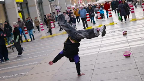 Talented breakdancer performing a handstand dance move on the street. Stock Footage 330684373