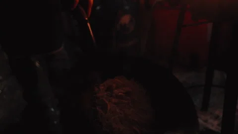 A talented chef expertly manages flames with wok in a lively and bustling street Stock Footage 302925237