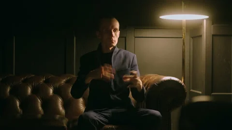 Talented dancer or actor performing robot dance, sitting on couch in living room Stock Footage 231221718