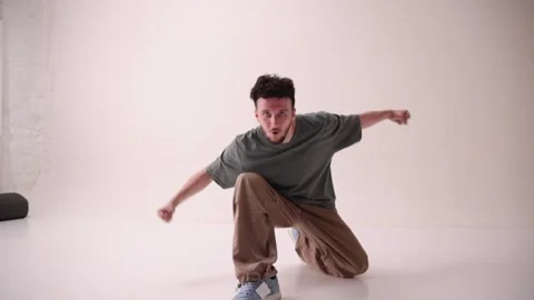 Talented dancer, young athletic man dressed streetstyle outfit and moves in Stock Footage 303347984