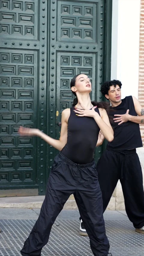 Talented dancers performing synchronized choreography on a city street Stock Footage 318828328