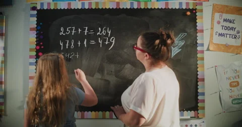 Talented Girl Solving Mathematical Problems on the Board. Female Teacher Stock Footage 313736801