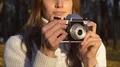 Talented girl taking pictures of beautiful autumn nature on old vintage camera HD Footage