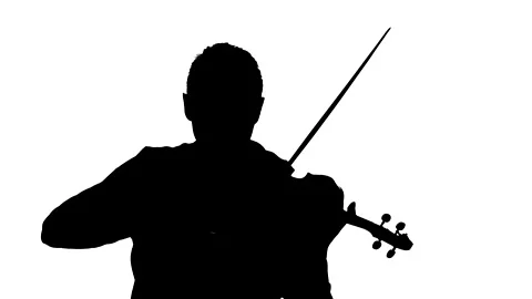 Talented guy plays the classic violin. Medium long shot. Silhouette Stock Footage 134522571