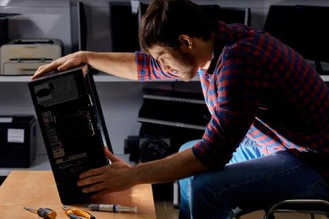 Talented man dealing with a broken computer Stock Photos
