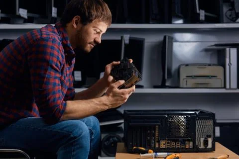 Talented man learning to fix broken PC Foto stock