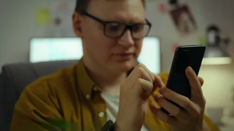 A talented programmer corrects the source code, working on software for phon Stock Footage 281107513