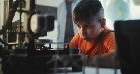 Talented Young Boy Sitting at Table, Studying Printing on Advanced Automated 3D Stock Footage 311672732