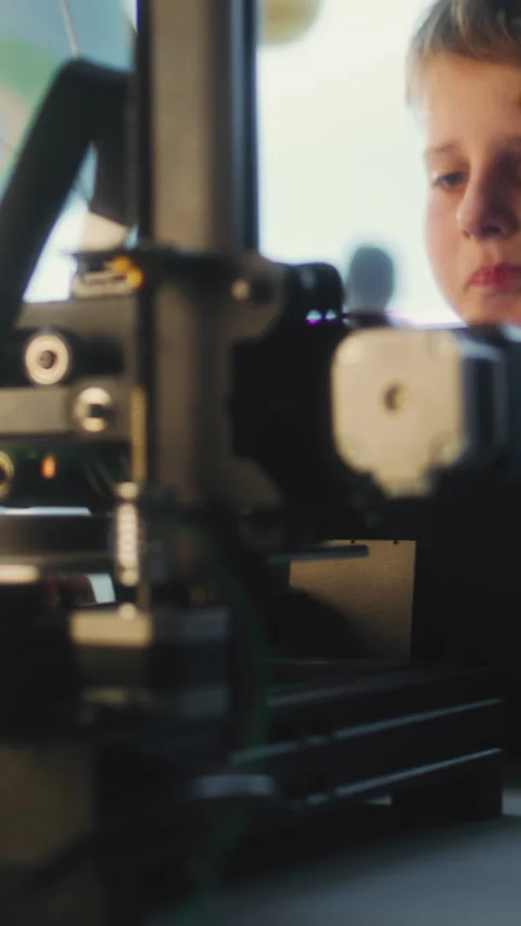 Talented Young Boy Sitting at Table, Writing Code for Automated 3D Printer on Stock Footage 311804473