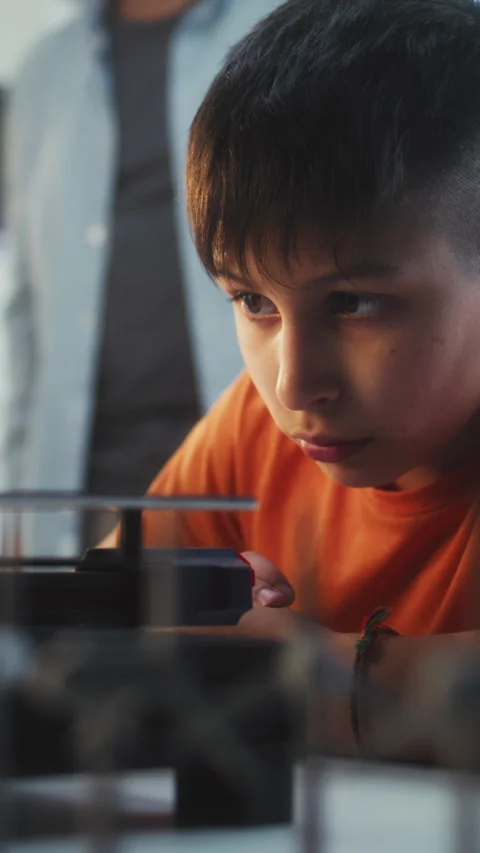 Talented Young Boy Sitting at Table, Studying Printing on Advanced Automated 3D Stock Footage 311804574