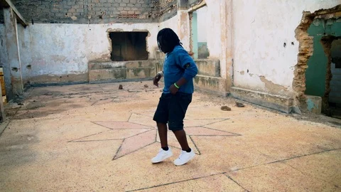 Talented young parkour guy doing tricks inside the ware house  Stock Footage 117675029