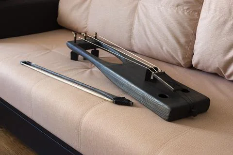 Talharpa - stringed musical instrument with a bow, on sofa Stock Photos