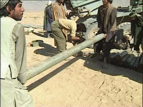 Taliban fighters loading rocket into multiple launcher. Stock Footage 10577728