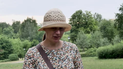 Talkative brunette with a straw hat worn over her eyes. 動画素材 273853491