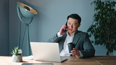 Talkative korean man having conversation through phone while resting in office Stock-Footage 275396731