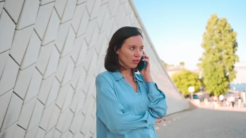 Talking about problems. Sad young caucasian female hold phone to ear discuss bad Stock-Footage 201521739