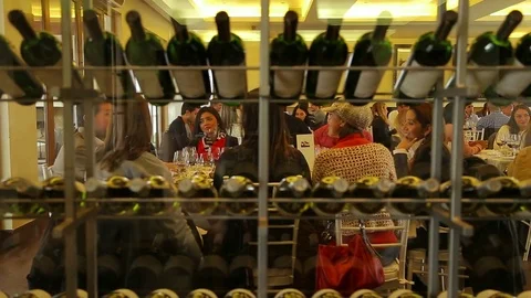 Talking behind wine display Stock Footage 77050878