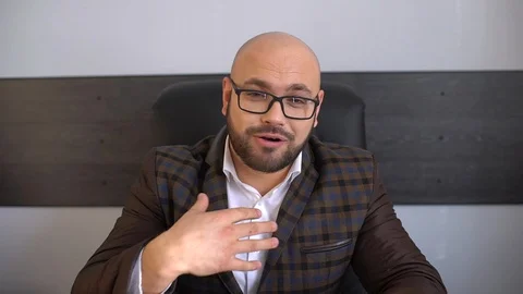 Talking to camera as if being interviewed or using computer or mobile camera to Stock Footage 86771782