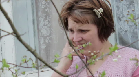 Talking on a cell through the trees Stock Footage 51637358