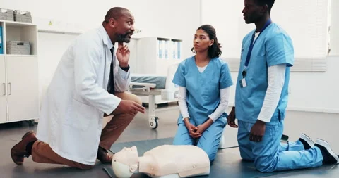 Talking, cpr and doctor with students for learning first aid, safety protocol or 库存影片 344299211