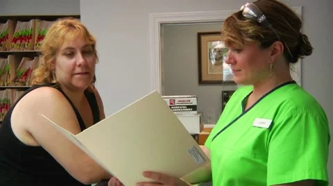Talking at dentist's reception desk Stock Footage 8652613