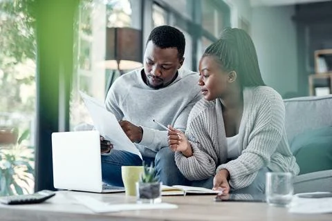 Talking, documents and black couple on laptop for finance, budget planning .. Stock Photos
