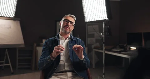 Talking, interview and man by lights on set for filming with documentary, show Stock Footage 303539247