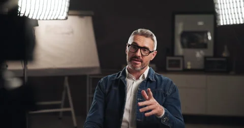 Talking, interview and man on set with camera for filming with documentary, show Stock Footage 303539164