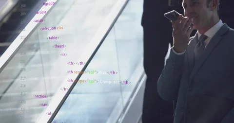 Talking man in suit speaking into smartphone in lobby with glass escalator Stock Footage 331634265