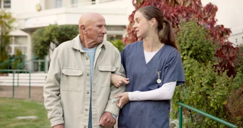 Talking, nurse and walking with old man outdoor, smile or recovery feedback with Stock Footage 340636808