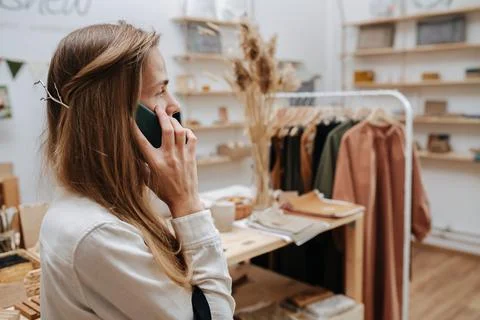 Talking on the phone against the store Stock Photos