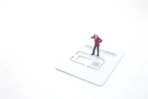 A Talking on the phone, the figure stand on the sim card Stock Photos