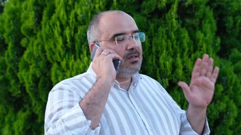 Talking on the phone, man talking to his wife on the phone Stock-Footage 162854610