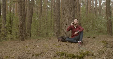 Talking on Smartphone in Forest Видео 109117096