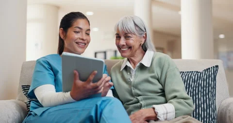Talking, tablet and nurse with old woman on sofa in home for consulting, medical Stock Footage 340000534