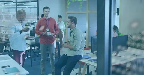 Talking three coworkers in open-plan office wearing red sweater and button-down, Stock Photos