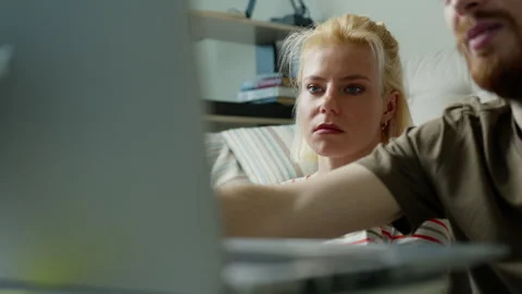 Talking young man using laptop near young woman. Stock Footage 262948663