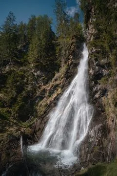 Tall Alpine Waterfall Falling Over Rocky Cliff in Tyrol Austria Fotos Stock