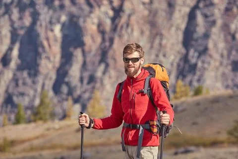 Tall backpacker with poles in hand. Foto stock