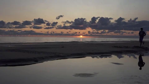 Tall backpacker watch clear sunny spring daybreak over sea. Stock Footage 126574789